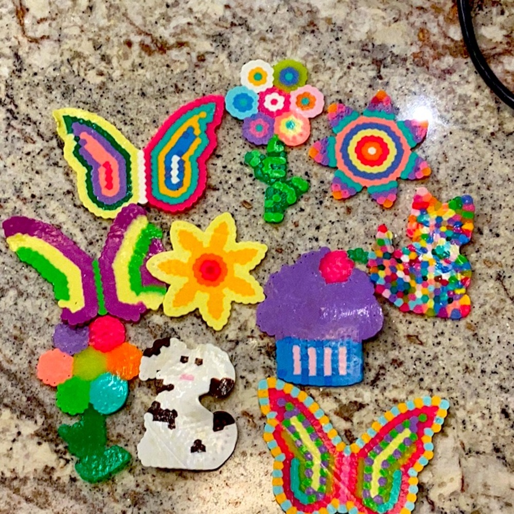 Colorful flower wall art pieces, a sun wall art piece, a fun wall art piece, etc